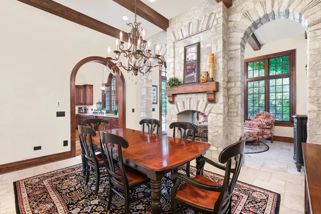 a dining room with furniture a rug and a chandelier