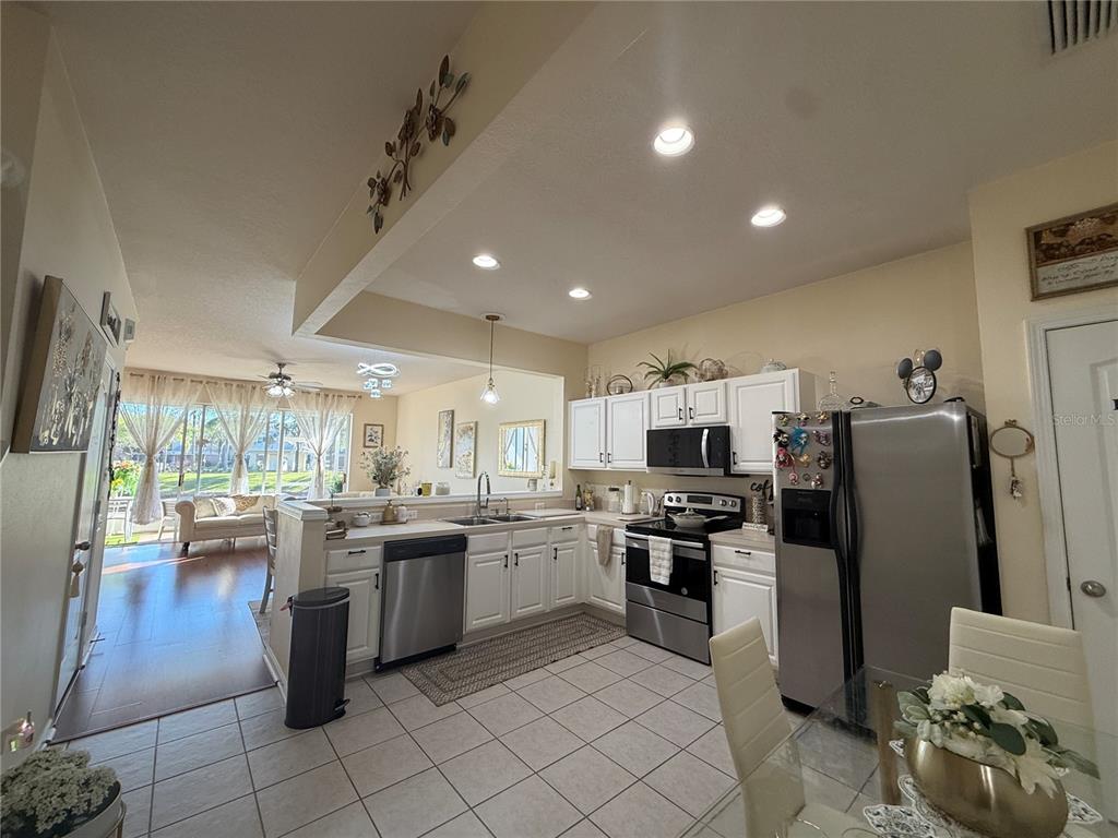 26642 Castleview Way Wesley Chapel, FL 33544 - Photo 11 of 50 a kitchen with refrigerator and cabinets