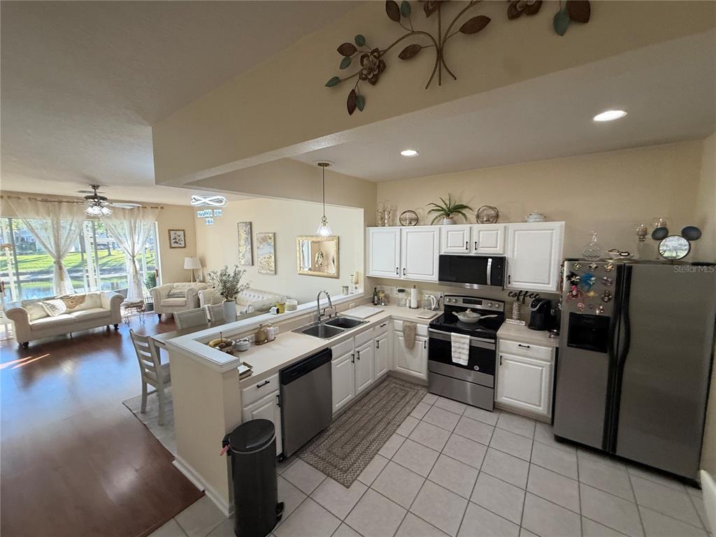 26642 Castleview Way Wesley Chapel, FL 33544 - Photo 14 of 50 a kitchen with granite countertop a sink stove and cabinets