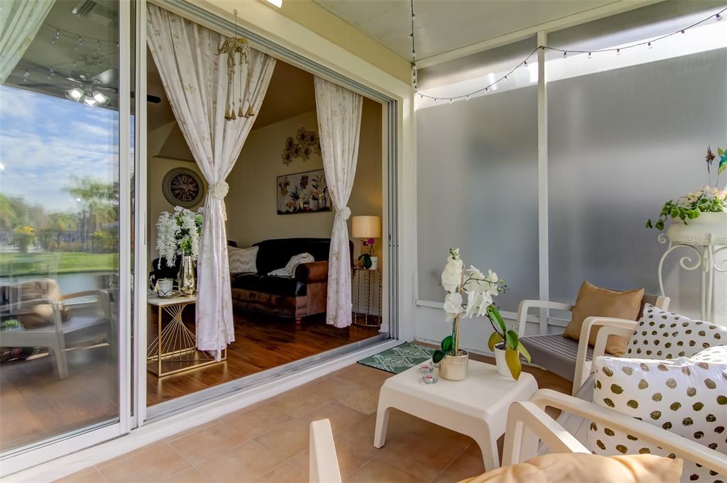 26642 Castleview Way Wesley Chapel, FL 33544 - Photo 24 of 50 a living room with furniture and a floor to ceiling window