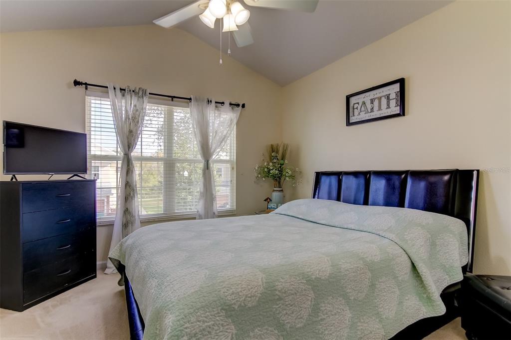 26642 Castleview Way Wesley Chapel, FL 33544 - Photo 28 of 50 a bedroom with a large bed and a tv