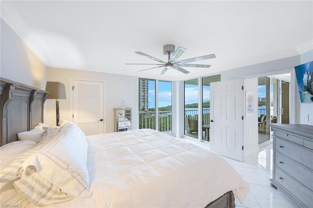 50 Seagate Drive, Unit 703 Naples, FL 34103 - Photo 21 of 34 a large white bed in a white room