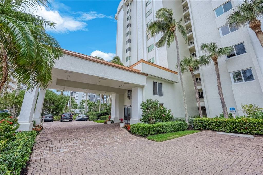 50 Seagate Drive, Unit 703 Naples, FL 34103 - Photo 28 of 34 a view of a house with a yard and plants