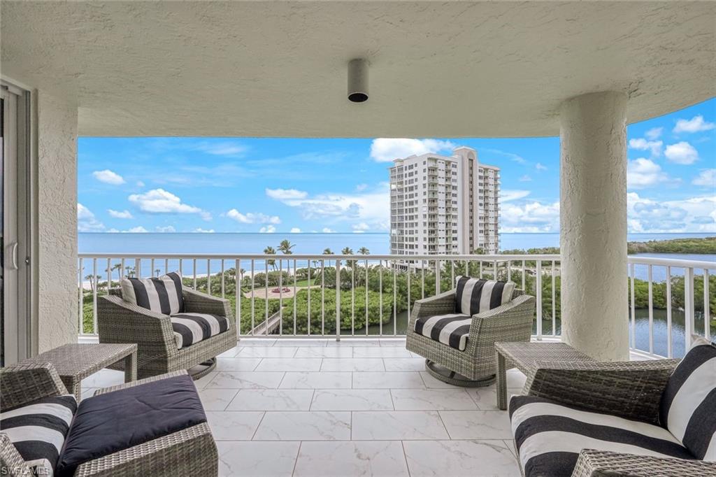 50 Seagate Drive, Unit 703 Naples, FL 34103 - Photo 3 of 34 a view of a balcony with couches and pool