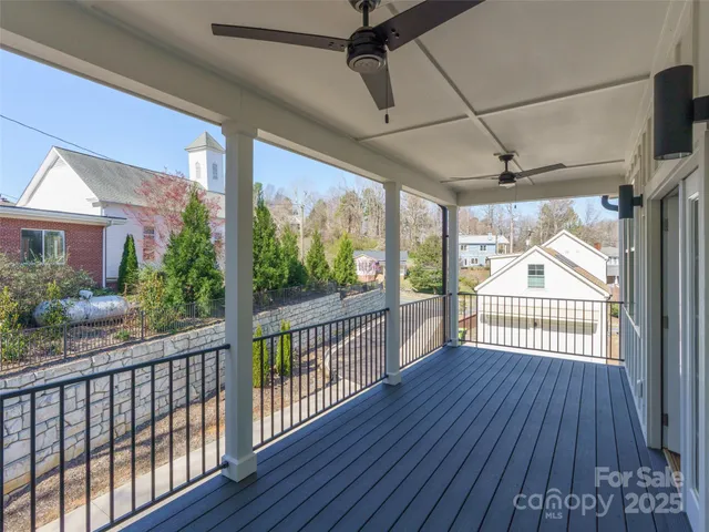 a view of a porch with wooden floor in front of house