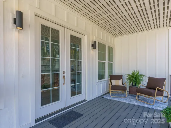 a view of front door of house with potted plants