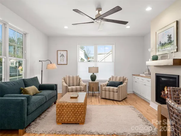 a living room with furniture a window and a fireplace
