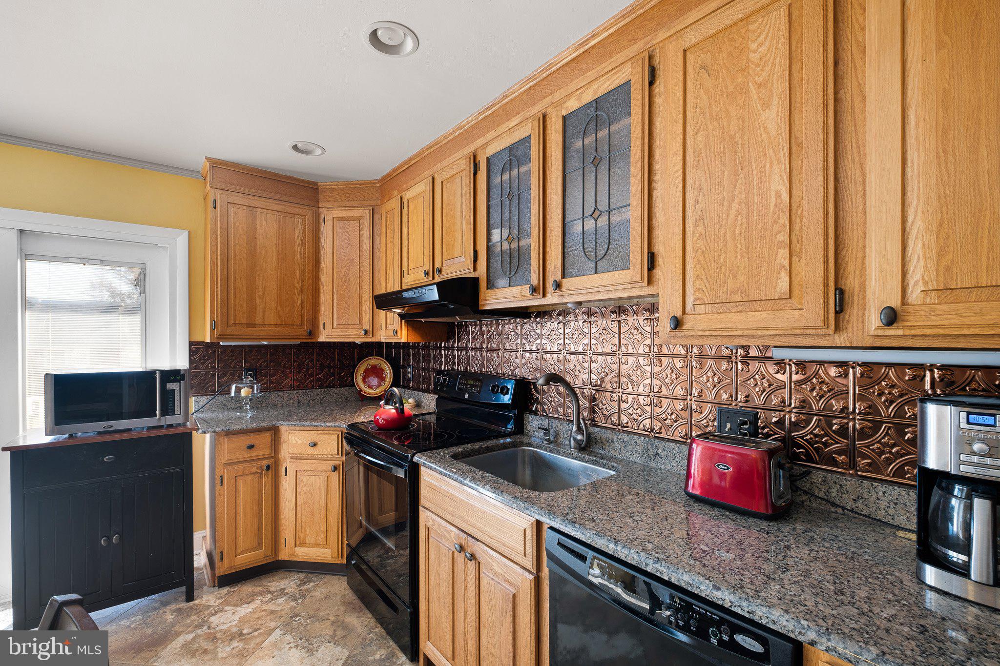 2124 Wrexham Road Wilmington, DE 19810 - Photo 9 of 28 a kitchen with stainless steel appliances granite countertop a sink stove and cabinets