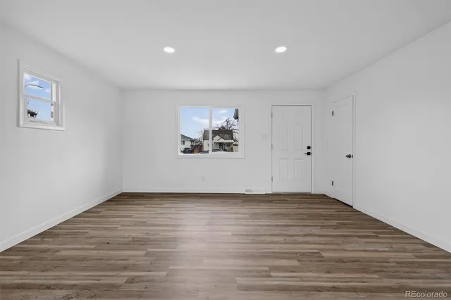 a view of an empty room with wooden floor
