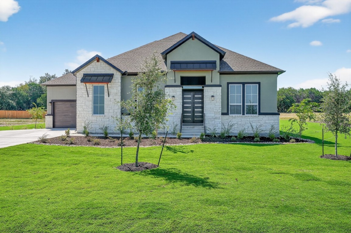 a view of a house with a yard and plants