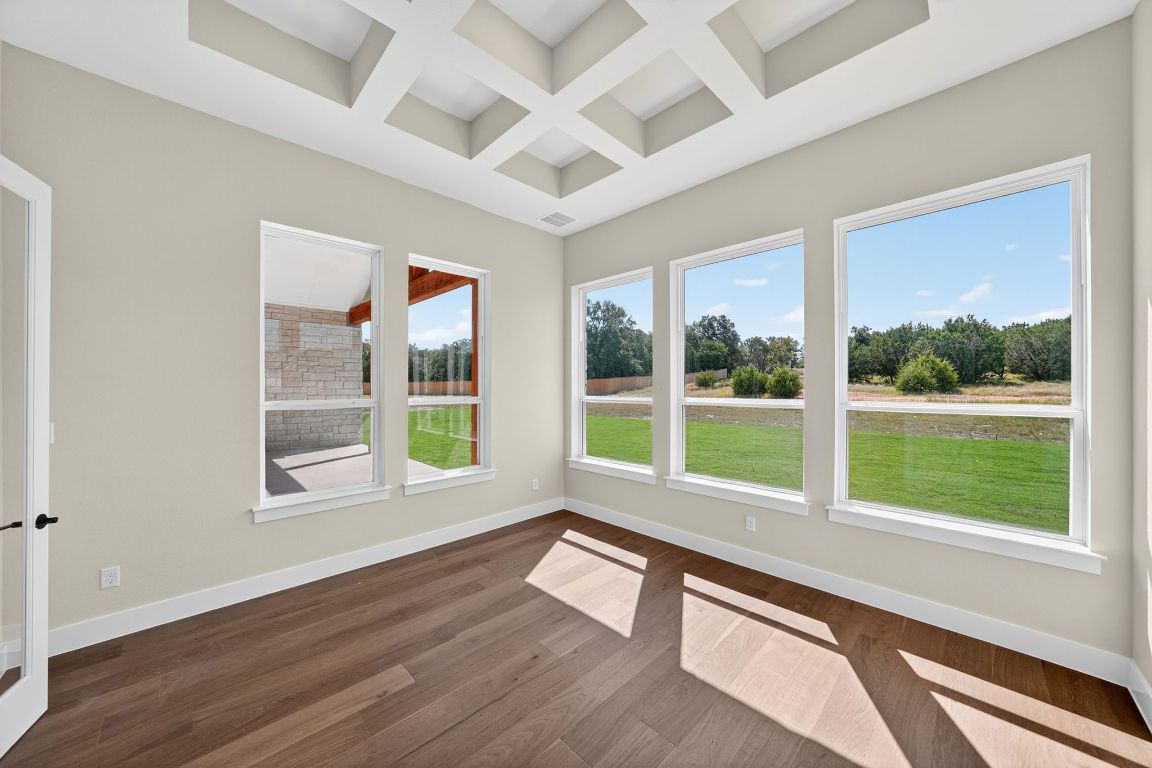 205 Three Rivers Road Georgetown, TX 78633 - Photo 10 of 32 a view of an empty room with wooden floor and a window