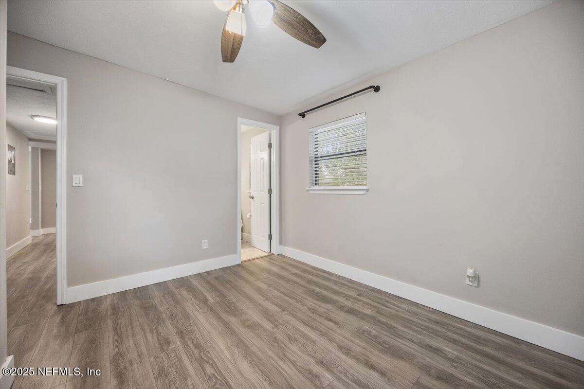 9379 Orme Road Jacksonville, FL 32220 - Photo 13 of 19 wooden floor in an empty room with a window