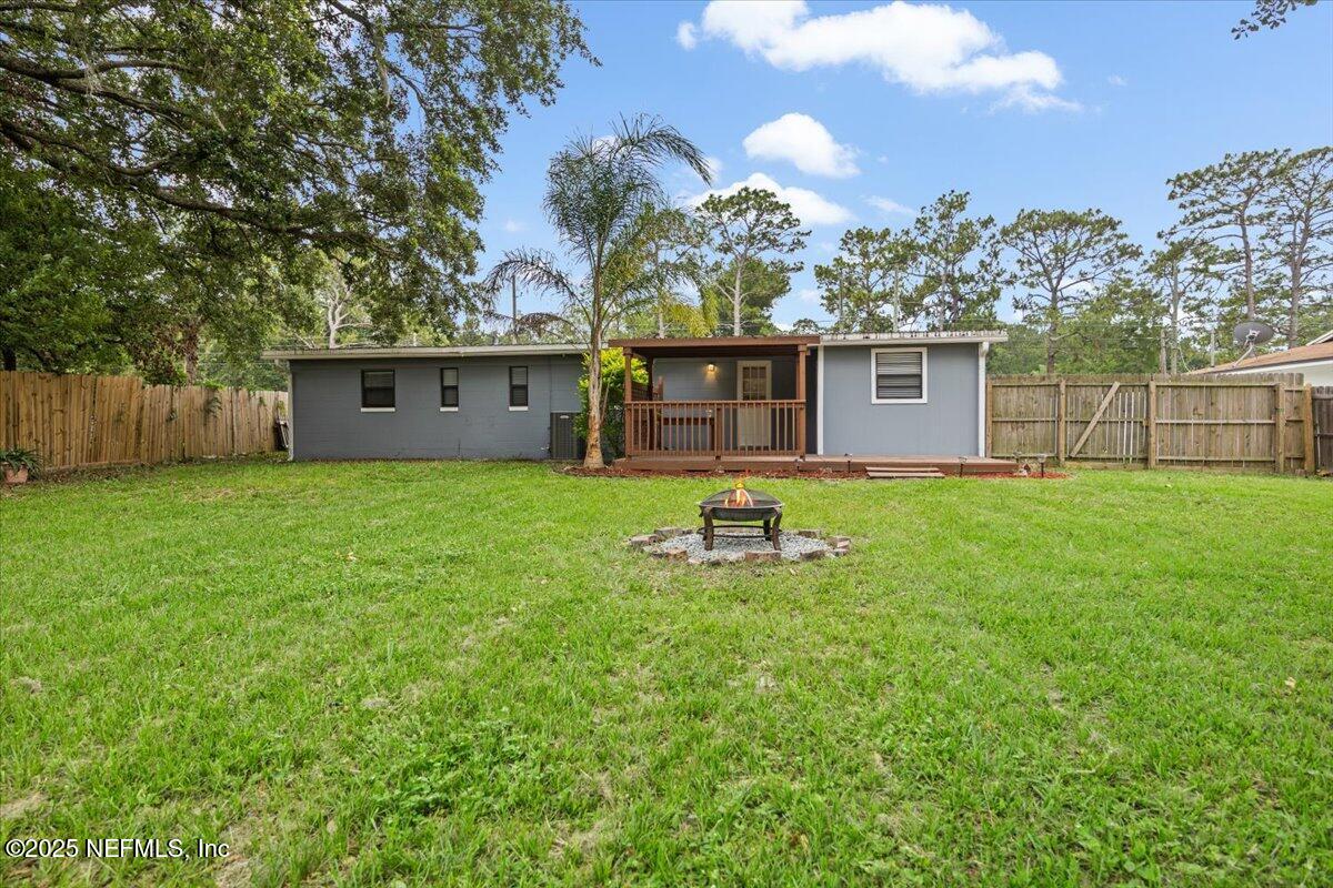9379 Orme Road Jacksonville, FL 32220 - Photo 19 of 19 a view of a house with patio and a yard