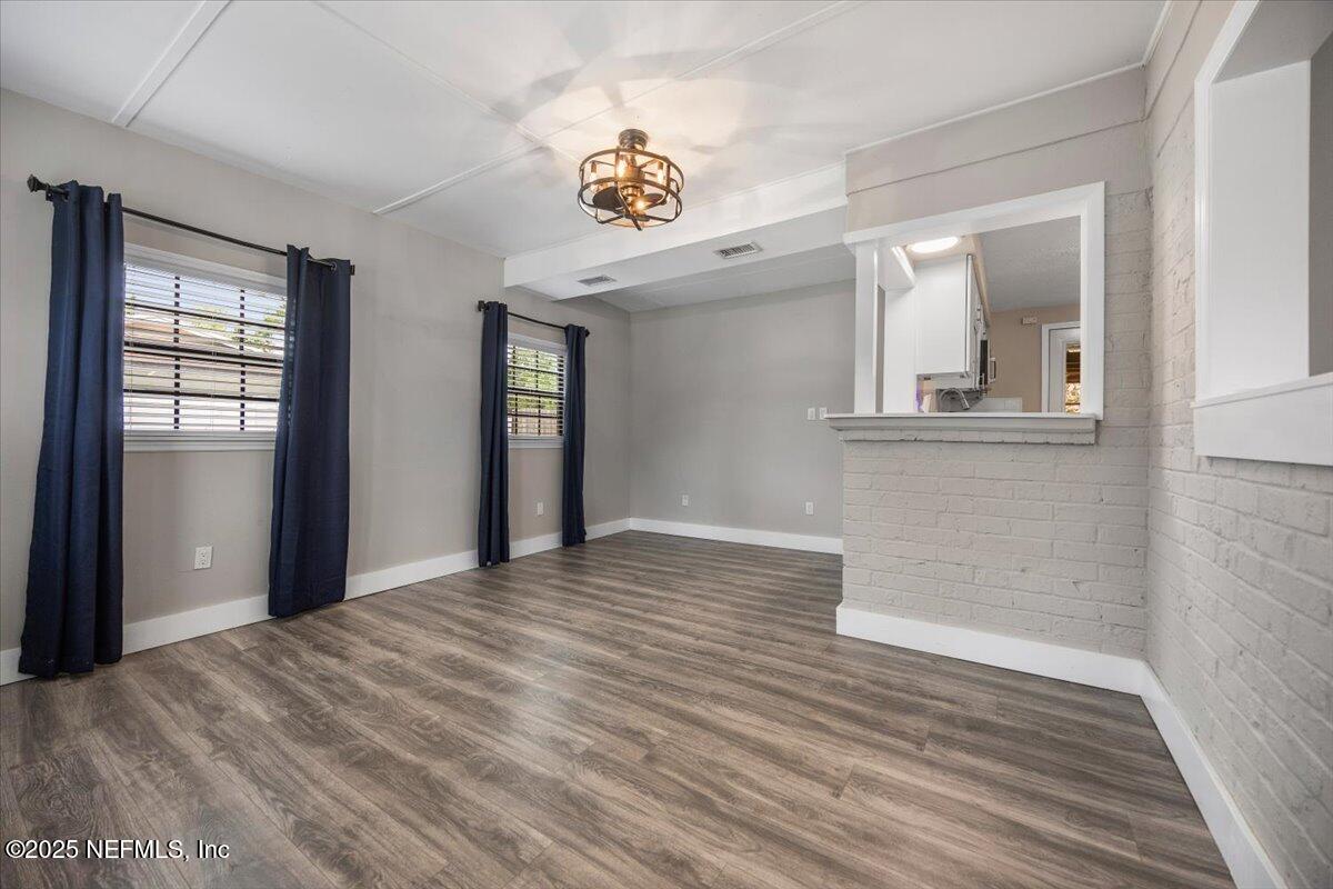 9379 Orme Road Jacksonville, FL 32220 - Photo 2 of 19 a view of a hallway with wooden floor and a window