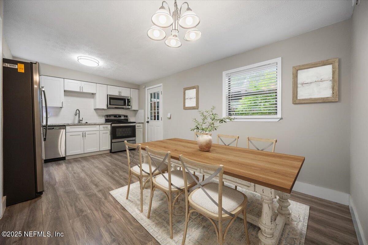 9379 Orme Road Jacksonville, FL 32220 - Photo 5 of 19 a kitchen with kitchen island a wooden floor and white appliances