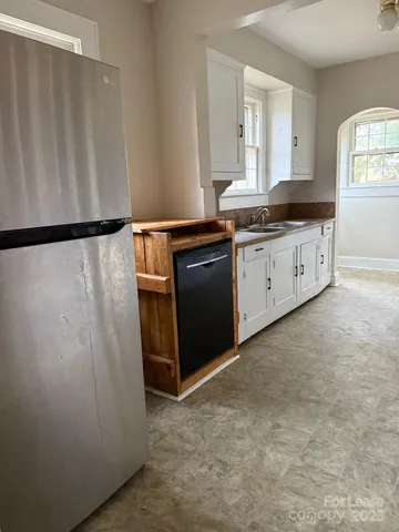 a kitchen with a refrigerator sink and stove