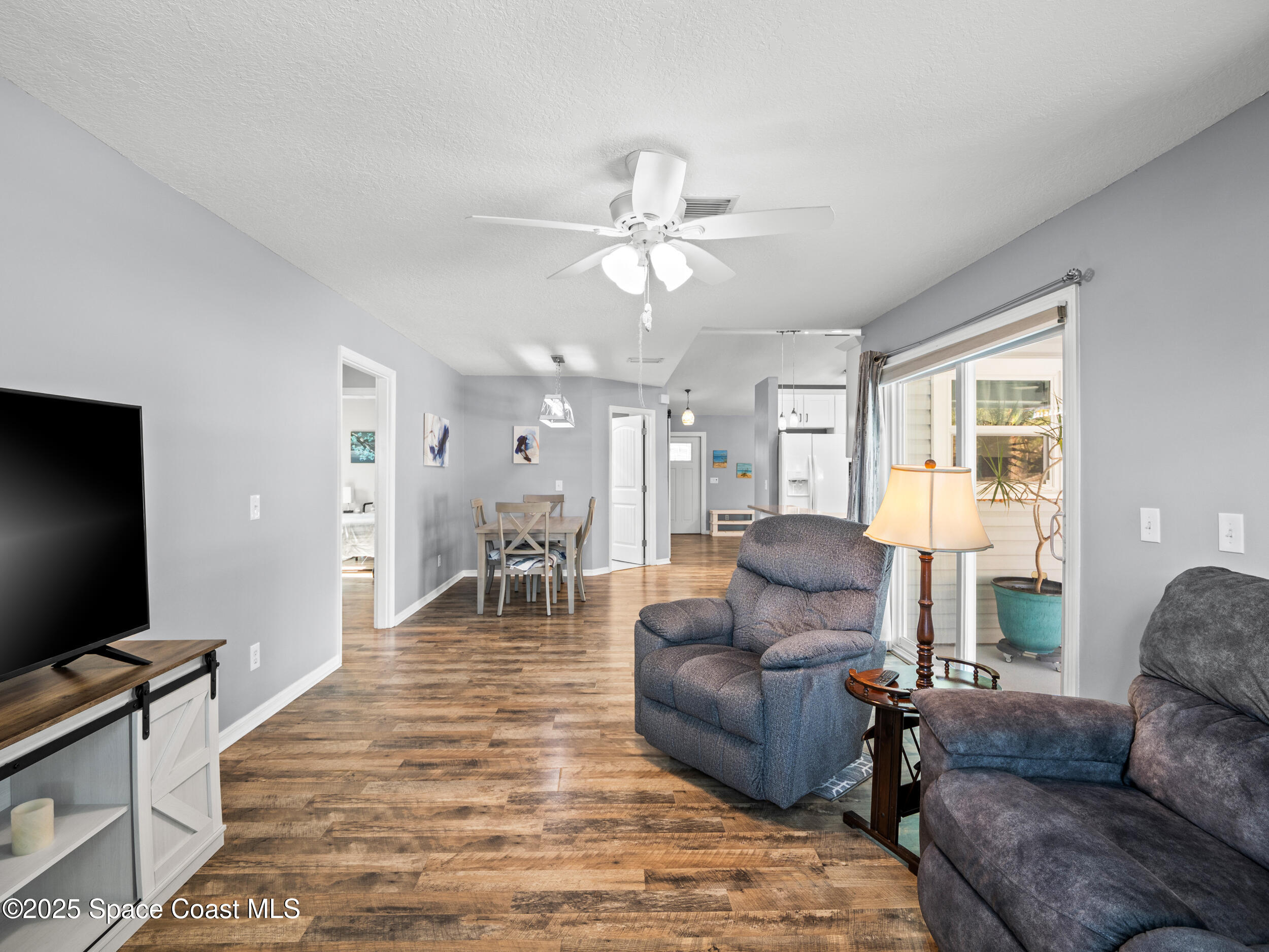 402 Watercrest Street Sebastian, FL 32958 - Photo 19 of 40 a living room with furniture and a flat screen tv