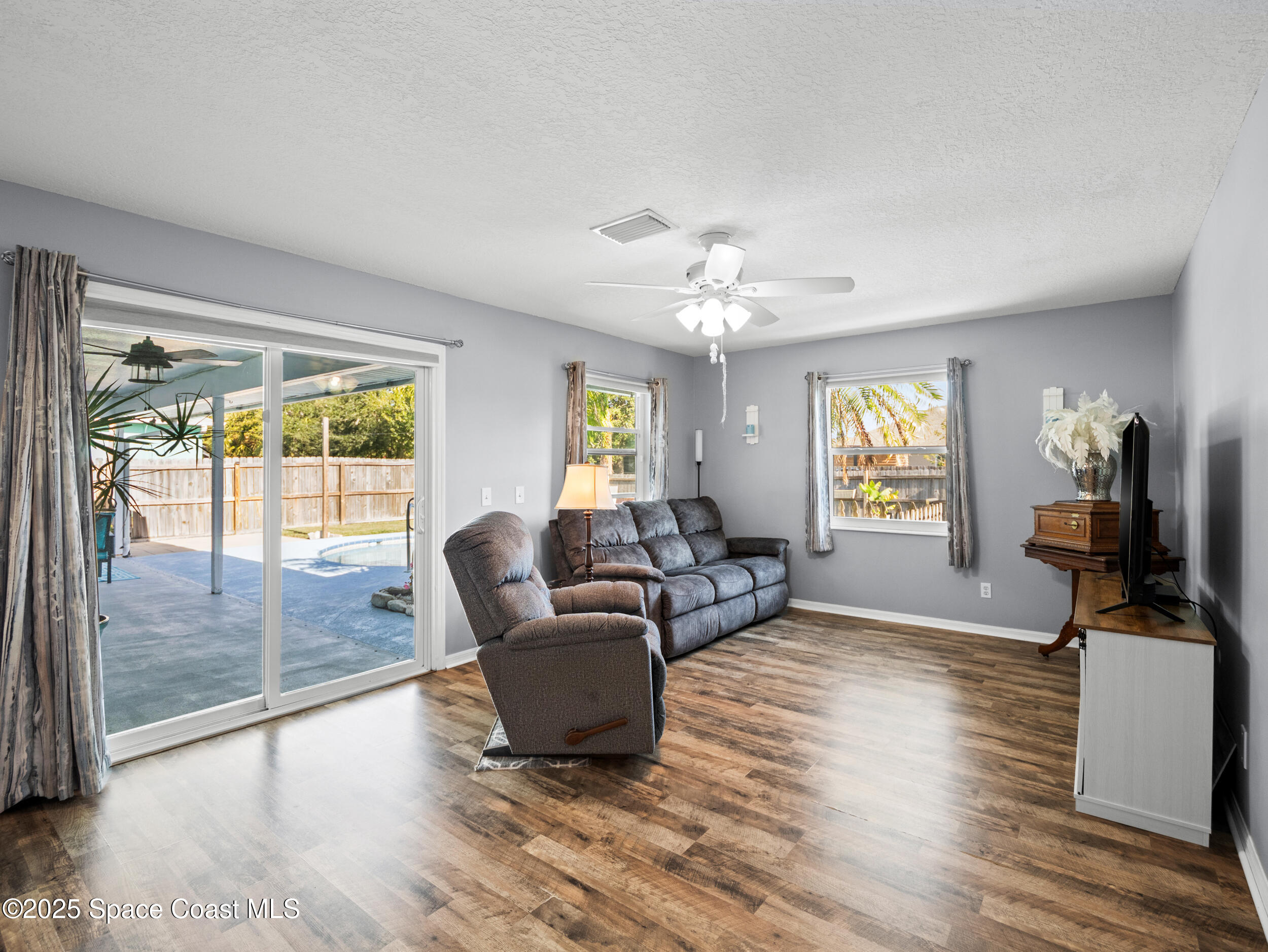 402 Watercrest Street Sebastian, FL 32958 - Photo 21 of 40 a living room with furniture and a flat screen tv