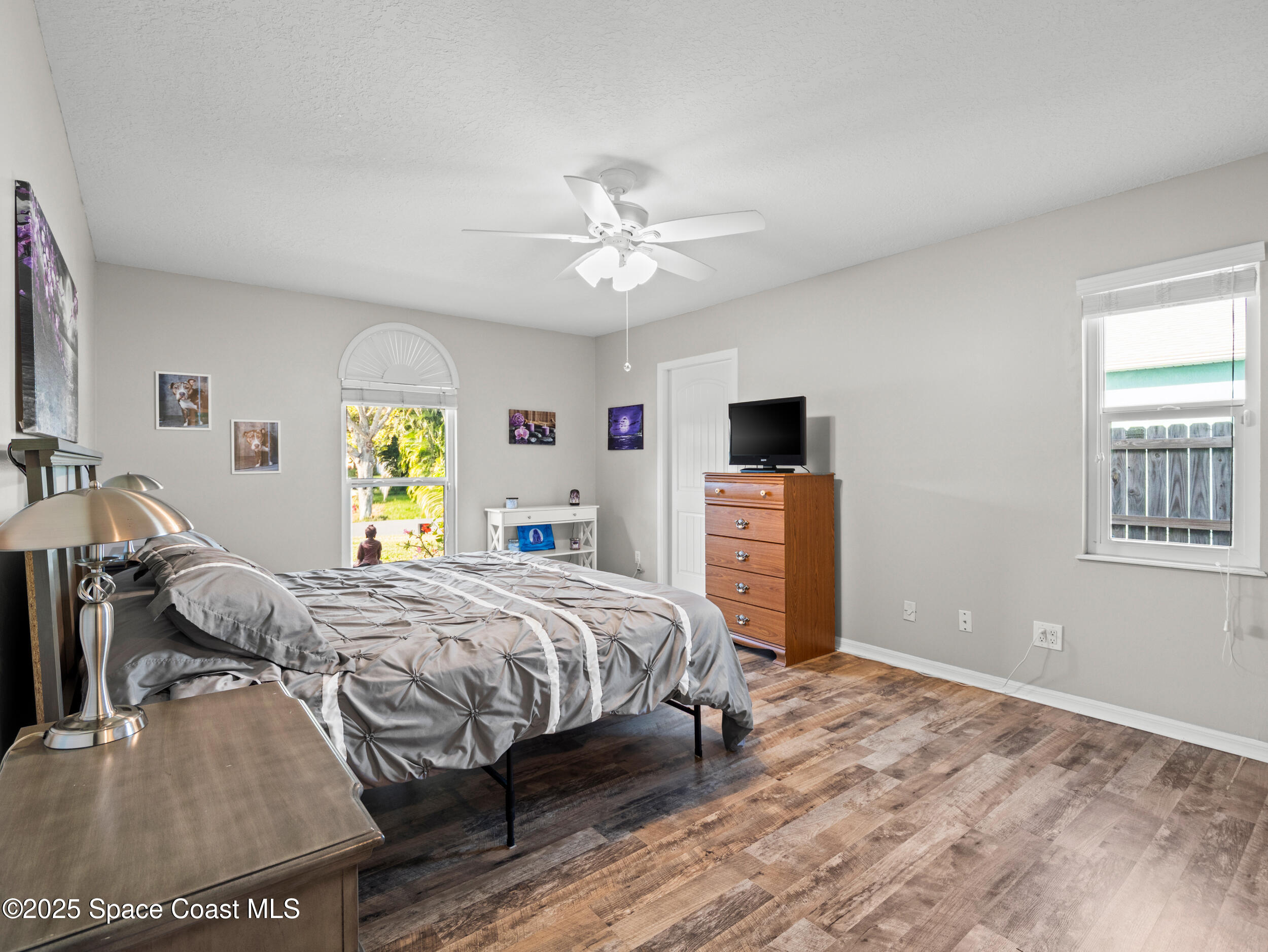 402 Watercrest Street Sebastian, FL 32958 - Photo 25 of 40 a bedroom with a bed and a chandelier