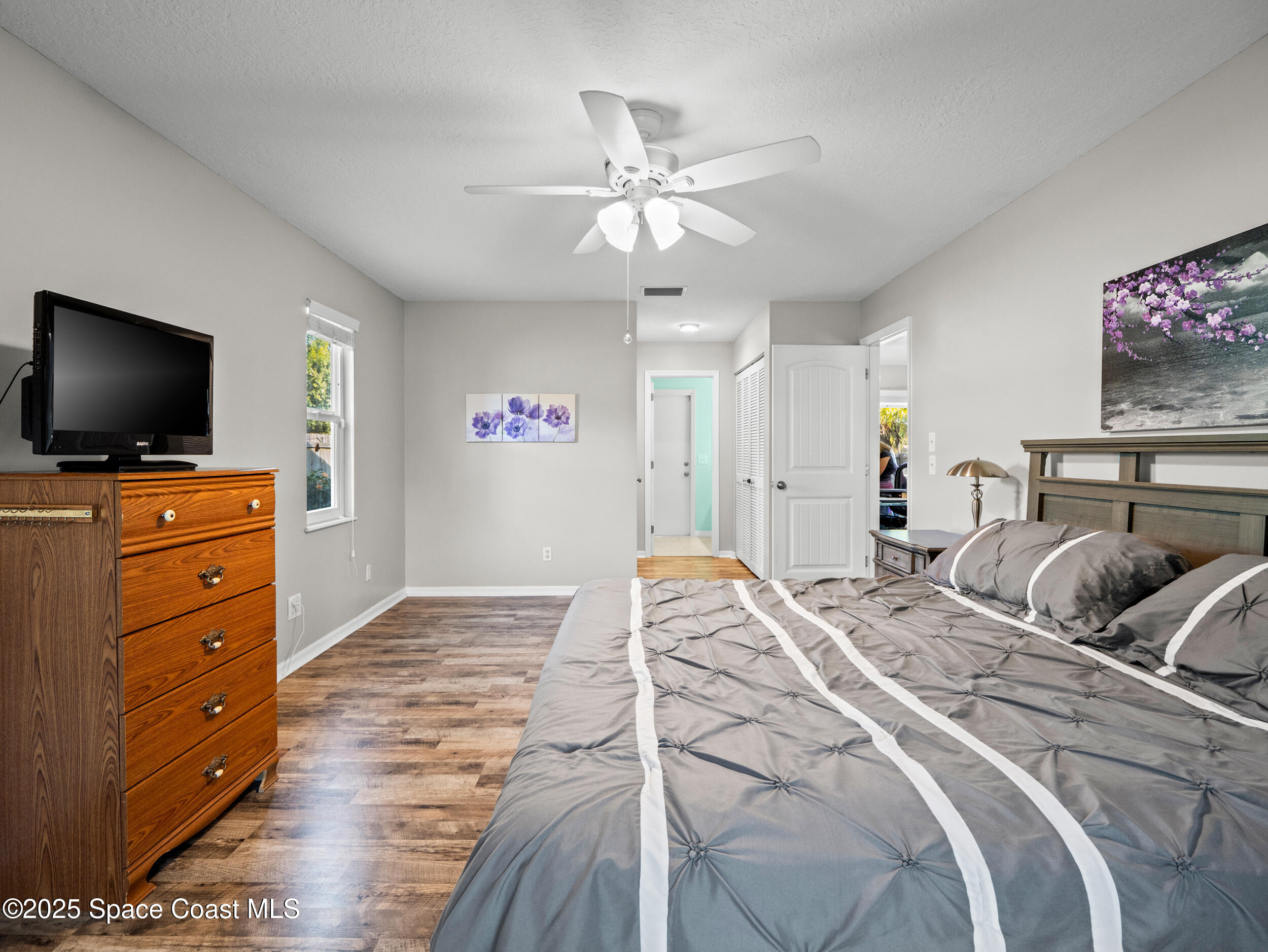 402 Watercrest Street Sebastian, FL 32958 - Photo 26 of 40 a bedroom with a bed and a flat screen tv