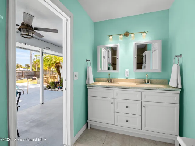 a bathroom with a sink vanity and mirror