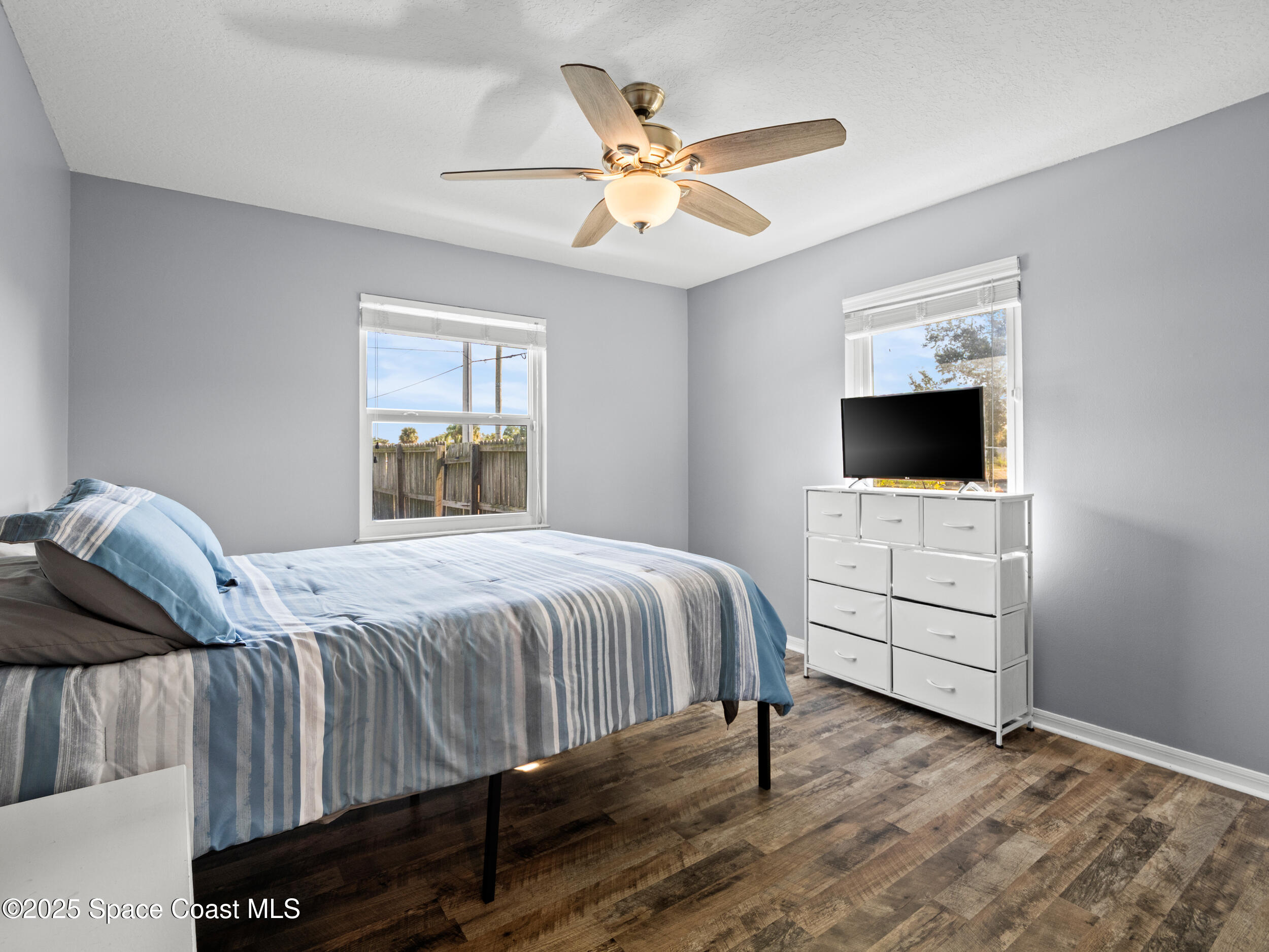 402 Watercrest Street Sebastian, FL 32958 - Photo 30 of 40 a bedroom with a bed and a flat screen tv