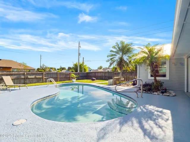 a view of a swimming pool with a lounge chair