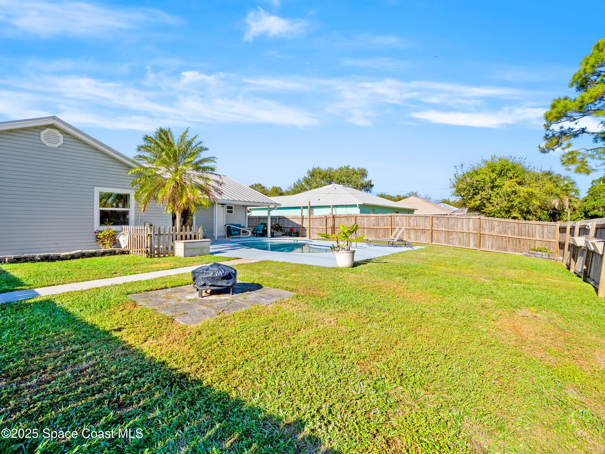 402 Watercrest Street Sebastian, FL 32958 - Photo 33 of 40 a swimming pool with outdoor seating and yard