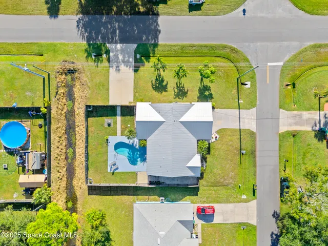a swimming pool with outdoor seating and yard