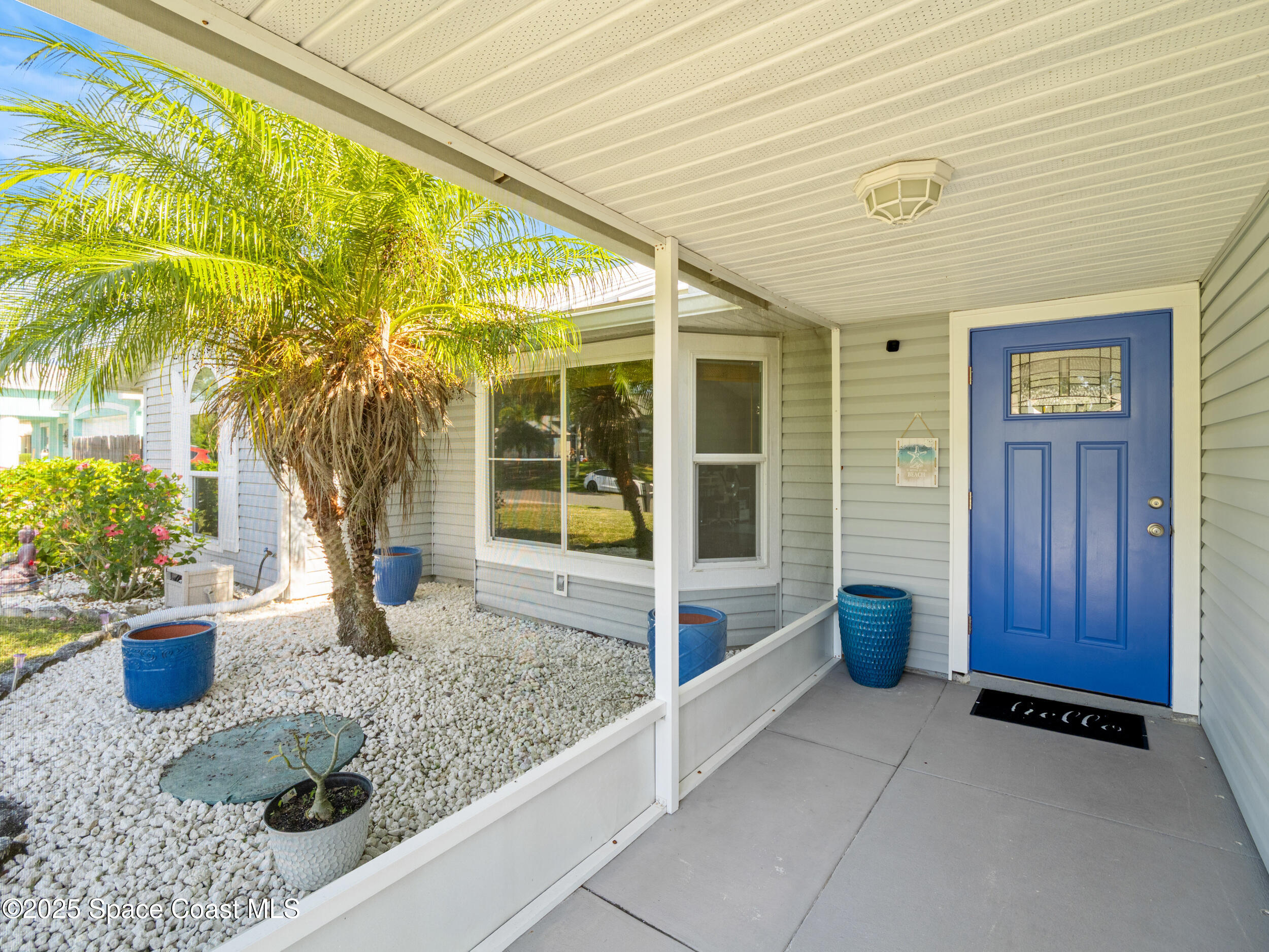 402 Watercrest Street Sebastian, FL 32958 - Photo 10 of 40 a view of a house with a potted plant and a garage
