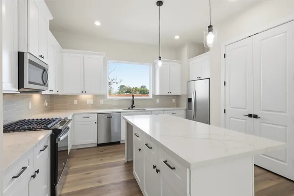 a kitchen with a sink stove and refrigerator