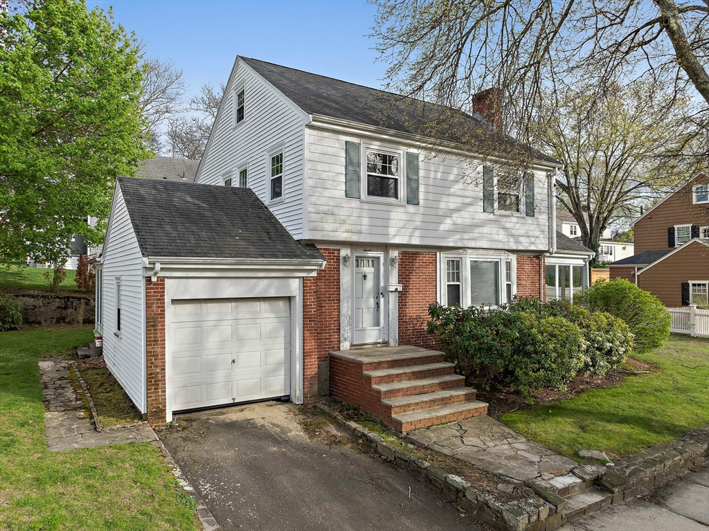a front view of a house with a garden