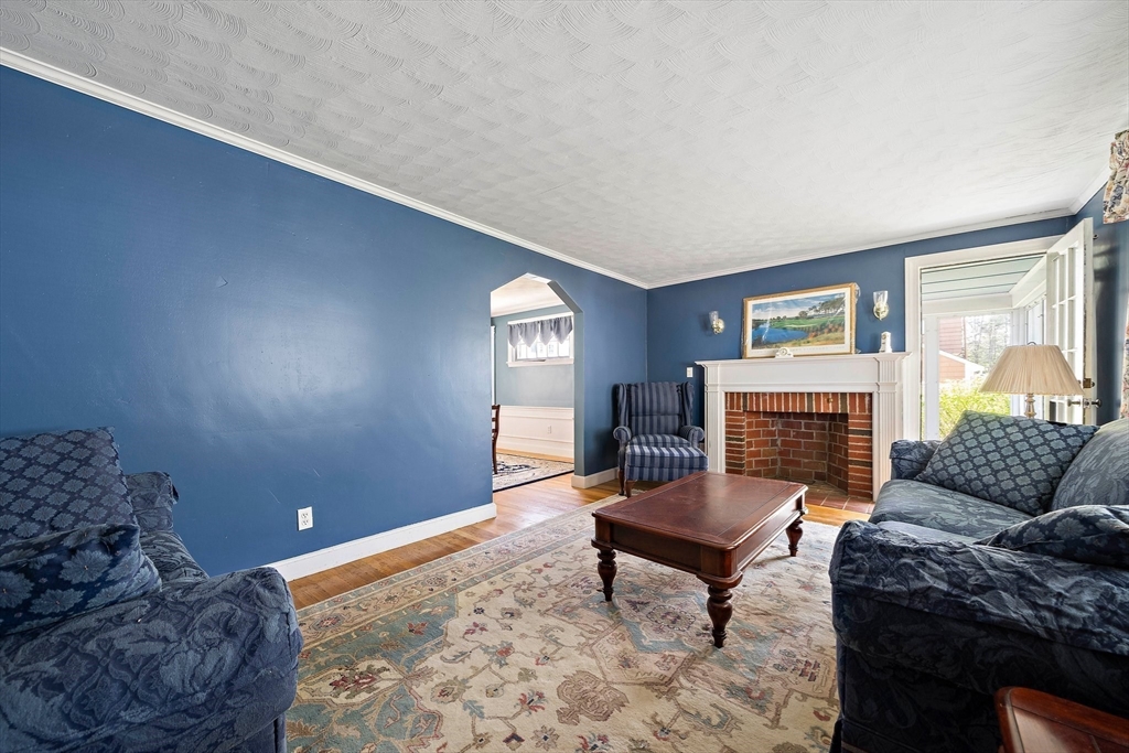 11 Latin Road Boston, MA 02132 - Photo 11 of 30 a living room with furniture a rug and a fireplace