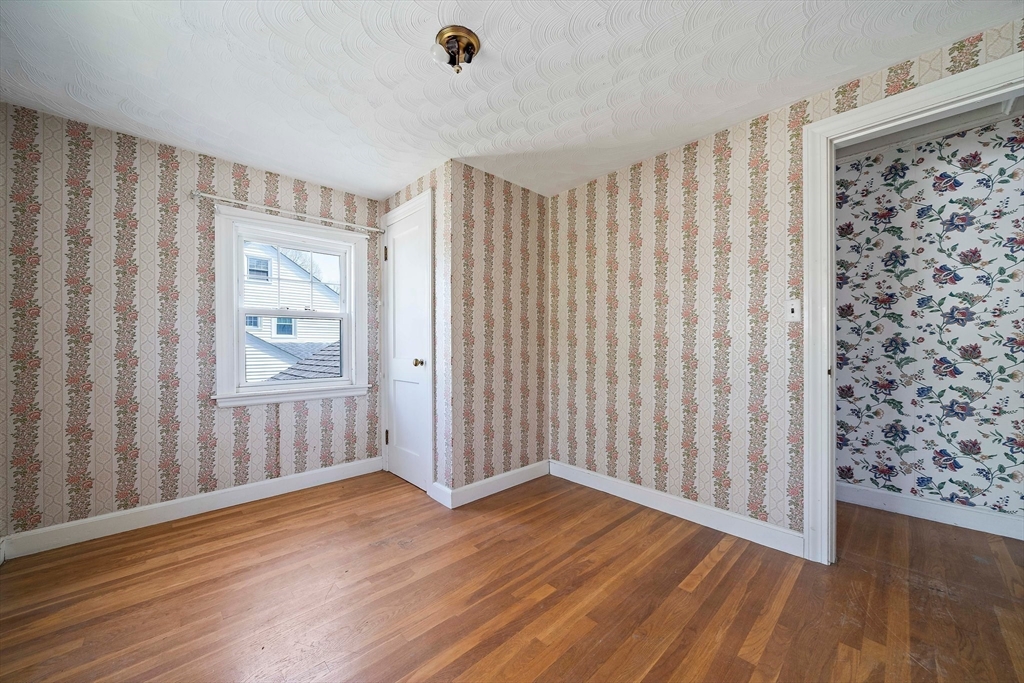 11 Latin Road Boston, MA 02132 - Photo 18 of 30 an empty room with wooden floor and windows