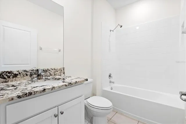a bathroom with a sink toilet vanity and shower