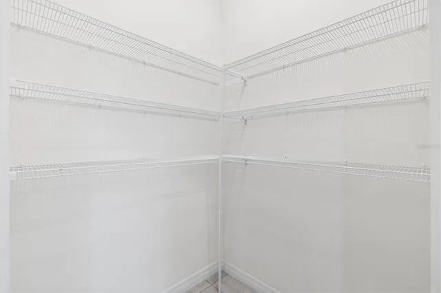 a view of a room with shelf on the wall