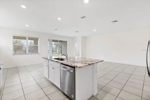 a kitchen with stainless steel appliances granite countertop a sink and a stove