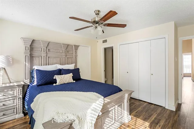 a bedroom with a large bed and a ceiling fan