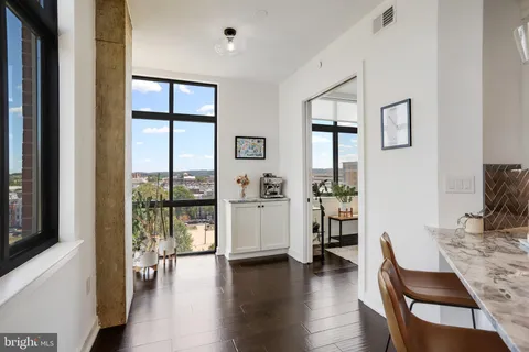 a view of an entryway with wooden floor and a potted plant