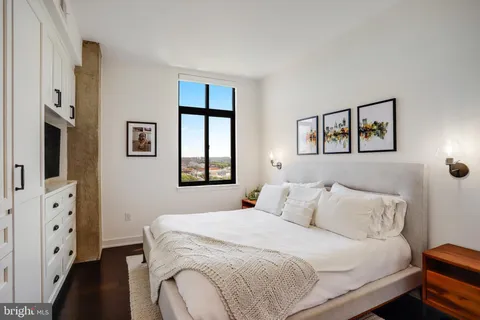 a bedroom with a large bed and a window
