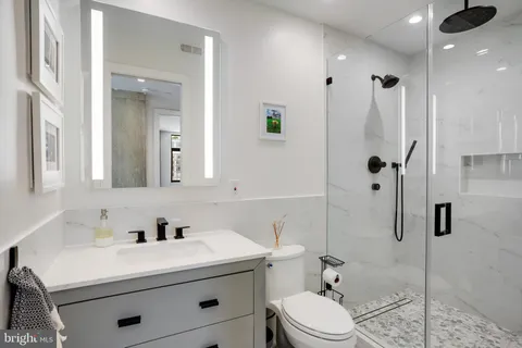 a living room with furniture tv and a large window