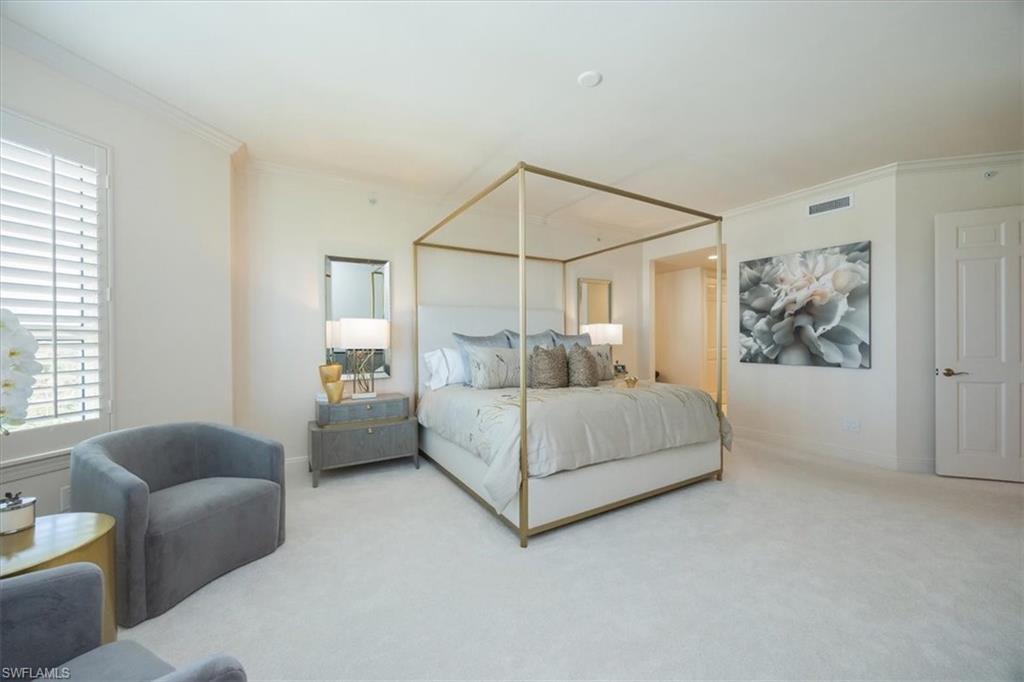 285 Grande Way, Unit 706 Naples, FL 34110 - Photo 12 of 24 a bedroom with a white bed couch and a window