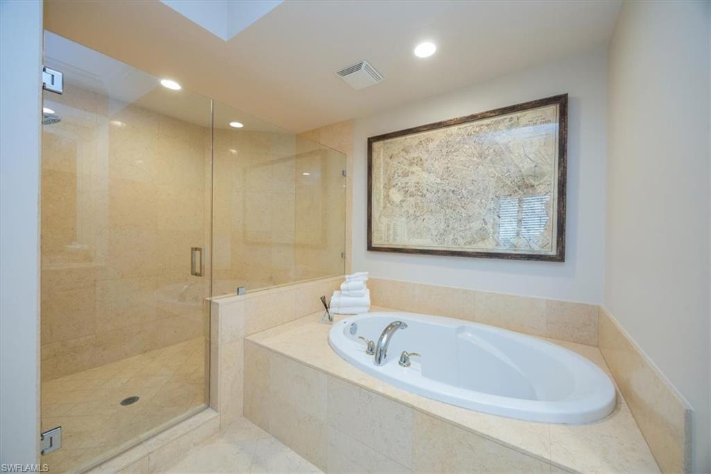 285 Grande Way, Unit 706 Naples, FL 34110 - Photo 14 of 24 a bathroom with a bathtub and shower