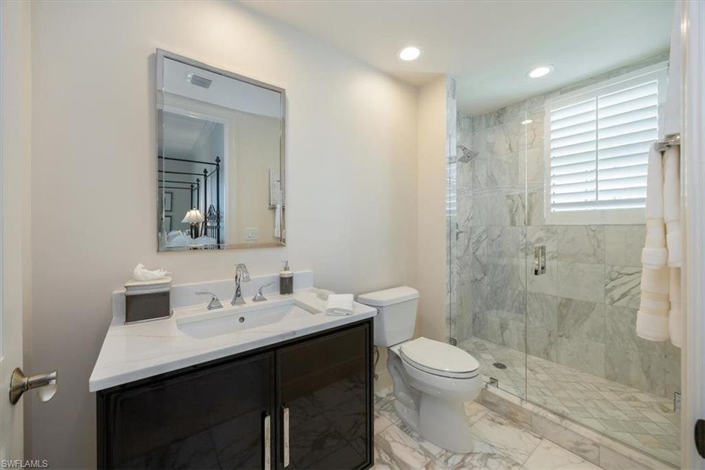 285 Grande Way, Unit 706 Naples, FL 34110 - Photo 20 of 24 a bathroom with a sink a toilet and shower