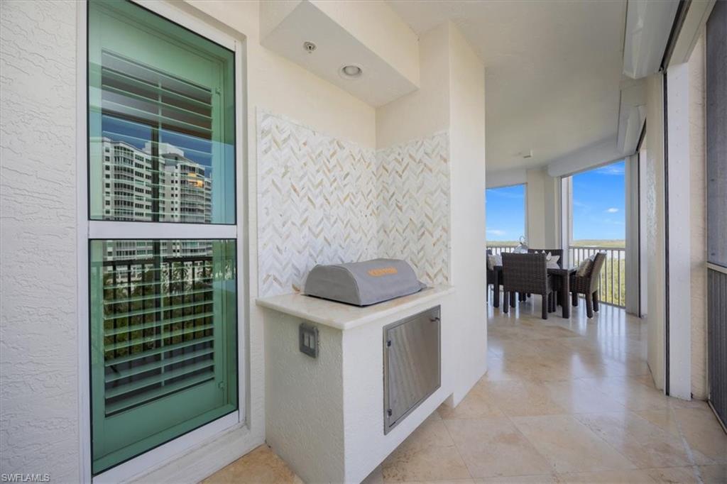 285 Grande Way, Unit 706 Naples, FL 34110 - Photo 21 of 24 a kitchen with table and chairs