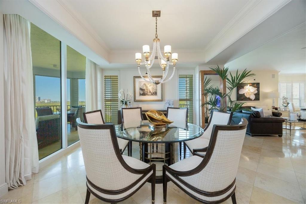 285 Grande Way, Unit 706 Naples, FL 34110 - Photo 4 of 24 a view of a dining room with furniture and window
