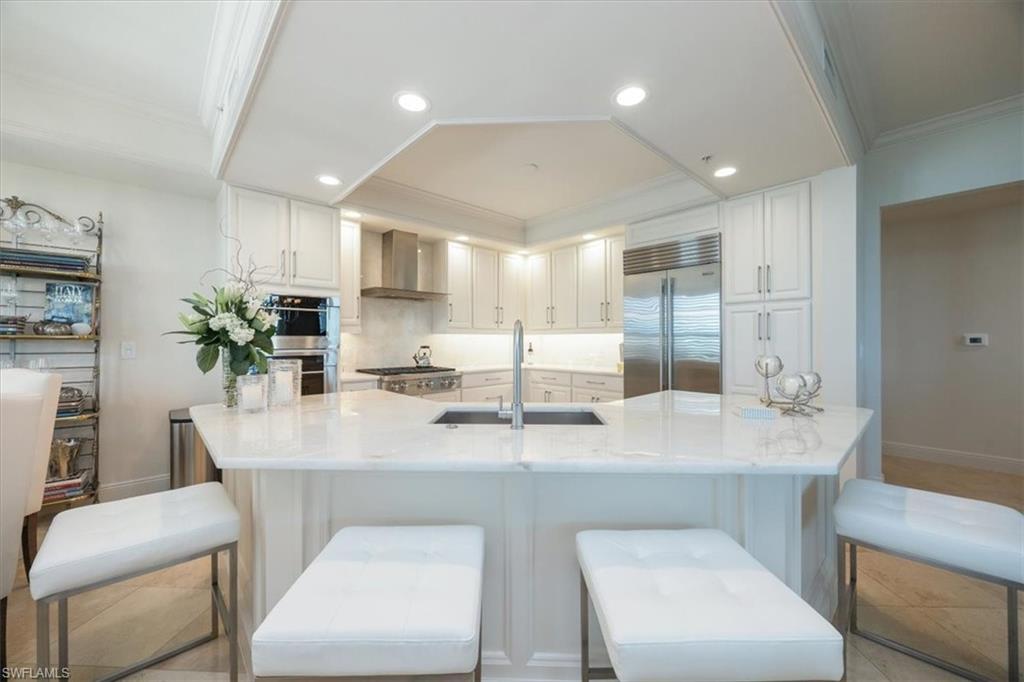 285 Grande Way, Unit 706 Naples, FL 34110 - Photo 7 of 24 a view of kitchen island kitchen island furniture and refrigerator
