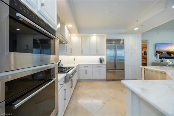 a large kitchen with a stove and a sink