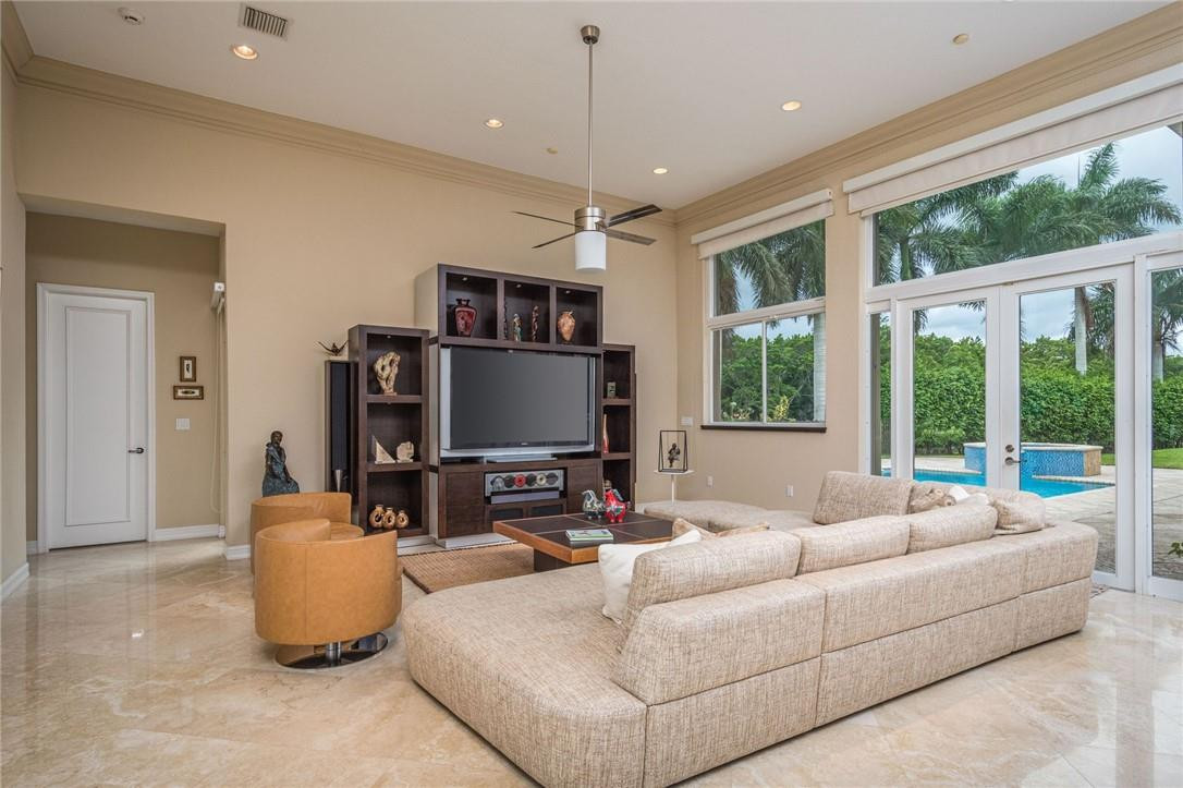 3620 Paddock Road Weston, FL 33331 - Photo 12 of 51 a living room with furniture a flat screen tv and a large window