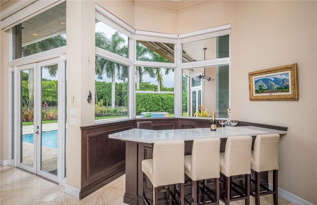 3620 Paddock Road Weston, FL 33331 - Photo 14 of 51 a dining room with a large window and table